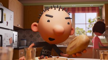 Movie still from “Diary of a Wimpy Kid” (2021), directed by Gino Nichele – A cartoon character is sitting at a table with food on it; Close Up shot, Over the shoulder angle
