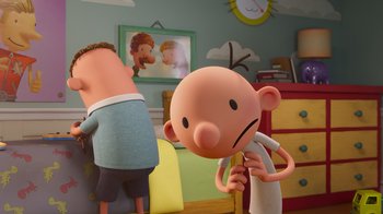 Movie still from “Diary of a Wimpy Kid” (2021), directed by Gino Nichele – A character's face in a scene from a cartoon; Medium shot, Over the shoulder angle