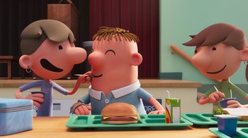 Movie still from “Diary of a Wimpy Kid” (2021), directed by Gino Nichele – A cartoon of a man eating a hamburger on a tray; Medium shot, Over the shoulder angle