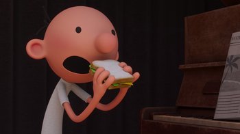 Movie still from “Diary of a Wimpy Kid” (2021), directed by Gino Nichele – A cartoon character is holding a sandwich in his hands; Extreme Close Up shot, Overhead angle