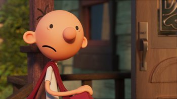 Movie still from “Diary of a Wimpy Kid” (2021), directed by Gino Nichele – A cartoon character with a frowning face sitting on a chair; Close Up shot, Low angle