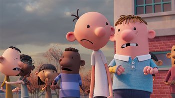 Movie still from “Diary of a Wimpy Kid” (2021), directed by Gino Nichele – A group of people standing next to each other in front of a building; Medium shot, Low angle