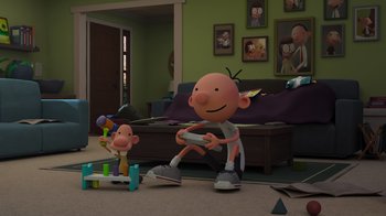 Movie still from “Diary of a Wimpy Kid: Rodrick Rules” (2022), directed by Gino Nichele – A cartoon character is playing a video game with a child; Wide shot, High angle