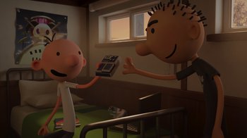 Movie still from “Diary of a Wimpy Kid: Rodrick Rules” (2022), directed by Gino Nichele – A cartoon of a man holding a book and another cartoon of a man holding a remote control; Medium shot, Over the shoulder angle