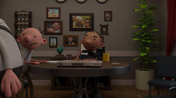 Movie still from “Diary of a Wimpy Kid: Rodrick Rules” (2022), directed by Gino Nichele – A man sitting at a table in front of a television; Wide shot, Over the shoulder angle