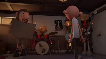 Movie still from “Diary of a Wimpy Kid: Rodrick Rules” (2022), directed by Gino Nichele – A group of people in a room playing drums; Wide shot, High angle