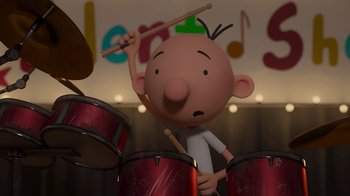 Movie still from “Diary of a Wimpy Kid: Rodrick Rules” (2022), directed by Gino Nichele – A cartoon character is playing drums with a stick; Medium shot, Over the shoulder angle