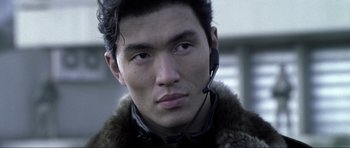 Movie still from “Die Another Day” (2002), directed by Lee Tamahori – A person wearing a headset; Close Up shot, Low angle