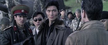 Movie still from “Die Another Day” (2002), directed by Lee Tamahori – A group of men standing next to each other; Close Up shot, Over the shoulder angle