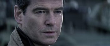 Movie still from “Die Another Day” (2002), directed by Lee Tamahori – Close up of a man's face in a black shirt; Close Up shot, Over the shoulder angle