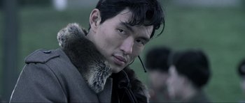 Movie still from “Die Another Day” (2002), directed by Lee Tamahori – A person wearing a coat; Close Up shot, Over the shoulder angle