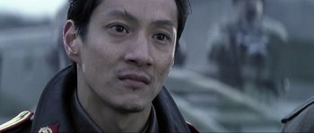 Movie still from “Die Another Day” (2002), directed by Lee Tamahori – A person wearing a black jacket; Close Up shot, Low angle