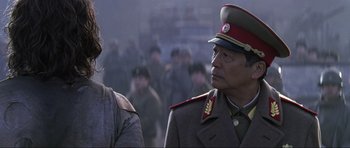 Movie still from “Die Another Day” (2002), directed by Lee Tamahori – A man in a military uniform is talking to another man in a military uniform; Close Up shot, Over the shoulder angle