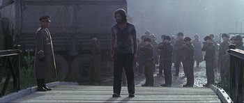 Movie still from “Die Another Day” (2002), directed by Lee Tamahori – A group of men standing next to each other on a bridge; Wide shot, Low angle