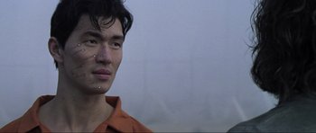 Movie still from “Die Another Day” (2002), directed by Lee Tamahori – A man with a nose ring is posing for a picture; Close Up shot, Low angle