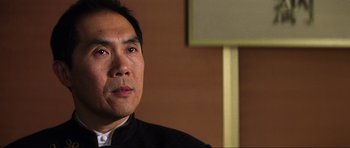 Movie still from “Die Another Day” (2002), directed by Lee Tamahori – A person wearing a black jacket; Close Up shot, Low angle