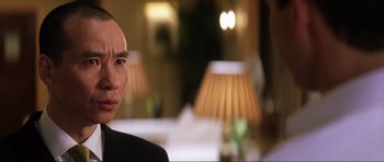 Movie still from “Die Another Day” (2002), directed by Lee Tamahori – A person wearing a suit; Close Up shot, Over the shoulder angle