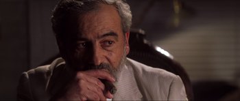 Movie still from “Die Another Day” (2002), directed by Lee Tamahori – An older man with grey hair and a white beard; Close Up shot, Low angle