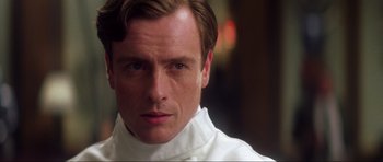 Movie still from “Die Another Day” (2002), directed by Lee Tamahori – A person wearing a white shirt; Close Up shot, Low angle