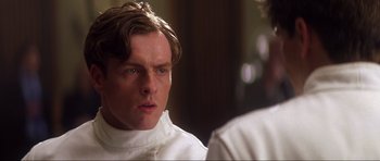 Movie still from “Die Another Day” (2002), directed by Lee Tamahori – A person wearing a white shirt; Close Up shot, Low angle