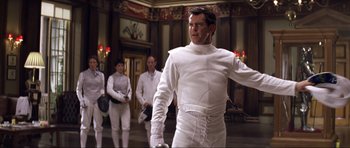 Movie still from “Die Another Day” (2002), directed by Lee Tamahori – A group of people dressed in white in a room; Medium shot, Low angle