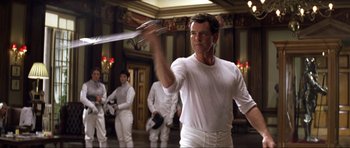 Movie still from “Die Another Day” (2002), directed by Lee Tamahori – A group of people dressed in all white holding swords; Medium shot, Low angle