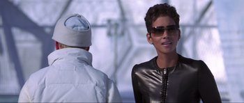 Movie still from “Die Another Day” (2002), directed by Lee Tamahori – A man and a woman wearing sunglasses and a leather jacket; Close Up shot, Over the shoulder angle