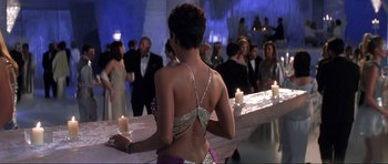 Movie still from “Die Another Day” (2002), directed by Lee Tamahori – A woman standing in front of a bar; Medium shot, Over the shoulder angle