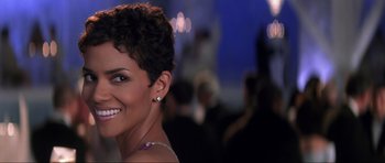 Movie still from “Die Another Day” (2002), directed by Lee Tamahori – A person with short curly hair; Close Up shot, Over the shoulder angle