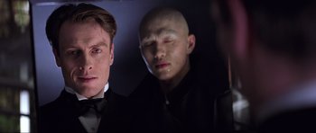 Movie still from “Die Another Day” (2002), directed by Lee Tamahori – A man in a suit and a bald man in a suit and a bald man; Close Up shot, Low angle