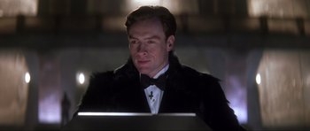 Movie still from “Die Another Day” (2002), directed by Lee Tamahori – A man in a black jacket and a bow tie; Close Up shot, Low angle