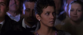 Movie still from “Die Another Day” (2002), directed by Lee Tamahori – A woman that is looking into the distance; Close Up shot, Over the shoulder angle