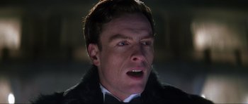 Movie still from “Die Another Day” (2002), directed by Lee Tamahori – A person wearing a suit and a bow tie; Close Up shot, Low angle