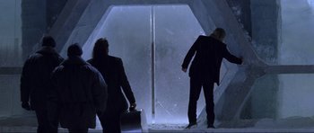Movie still from “Die Another Day” (2002), directed by Lee Tamahori – Two people are standing in an ice cave; Wide shot, Low angle