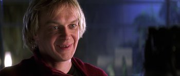 Movie still from “Die Another Day” (2002), directed by Lee Tamahori – A person with blonde hair; Close Up shot, Low angle