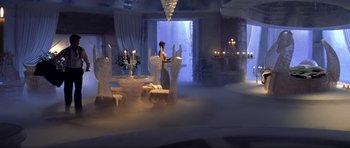 Movie still from “Die Another Day” (2002), directed by Lee Tamahori – A person standing in a room with a bunch of candles; Extreme Wide shot, High angle