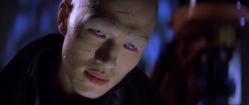 Movie still from “Die Another Day” (2002), directed by Lee Tamahori – A person with blue eyes; Close Up shot, Low angle