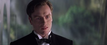 Movie still from “Die Another Day” (2002), directed by Lee Tamahori – A person wearing a suit and bow tie; Close Up shot, Low angle