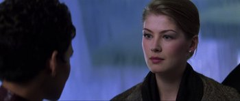 Movie still from “Die Another Day” (2002), directed by Lee Tamahori – A person sitting in front of another person; Close Up shot, Over the shoulder angle