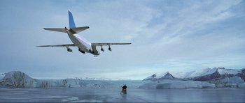 Movie still from “Die Another Day” (2002), directed by Lee Tamahori – An airplane is flying low over a body of water; Extreme Wide shot, Low angle