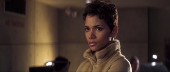 Movie still from “Die Another Day” (2002), directed by Lee Tamahori – A person with short hair; Close Up shot, High angle