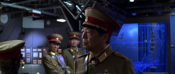 Movie still from “Die Another Day” (2002), directed by Lee Tamahori – A group of men in military uniforms standing next to each other; Medium shot, Over the shoulder angle