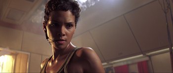 Movie still from “Die Another Day” (2002), directed by Lee Tamahori – A woman that is posing for a picture; Close Up shot, Low angle