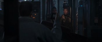 Movie still from “Die Hard 2” (1990), directed by Renny Harlin – A group of men sitting on top of a bus; Medium shot, Over the shoulder angle