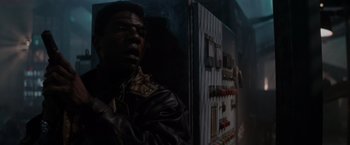 Movie still from “Die Hard 2” (1990), directed by Renny Harlin – A man in a leather jacket looking at the camera; Close Up shot, Low angle