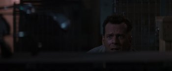 Movie still from “Die Hard 2” (1990), directed by Renny Harlin – A person looking at the camera; Close Up shot, Low angle