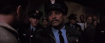 Movie still from “Die Hard 2” (1990), directed by Renny Harlin – A group of men in police uniforms standing next to each other; Close Up shot, Low angle