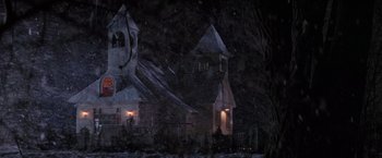 Movie still from “Die Hard 2” (1990), directed by Renny Harlin – A church in the middle of the night with snow on the ground; Extreme Wide shot, Low angle