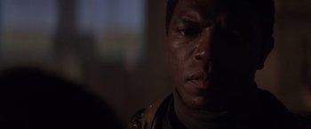 Movie still from “Die Hard 2” (1990), directed by Renny Harlin – A man's face in a dark room; Close Up shot, Low angle