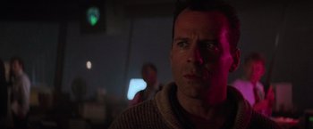 Movie still from “Die Hard 2” (1990), directed by Renny Harlin – A person in a dark room; Close Up shot, Low angle